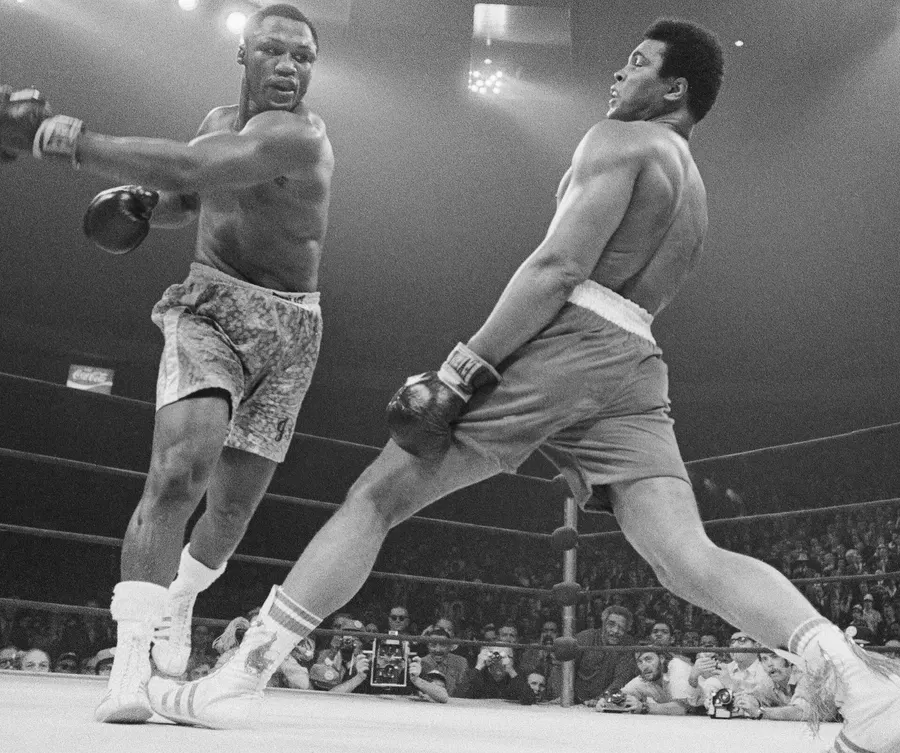 Muhammad Ali avoids a punch from Joe Frazier during their first fight, 8 March 1971.
