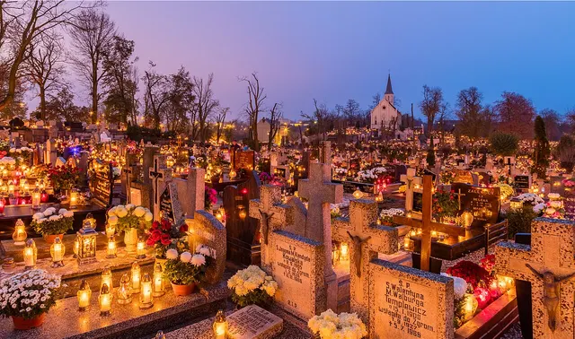 Candles on graves at Holy Cross Cemetery, Gniezno, Poland, on All Saints' Day 2017.