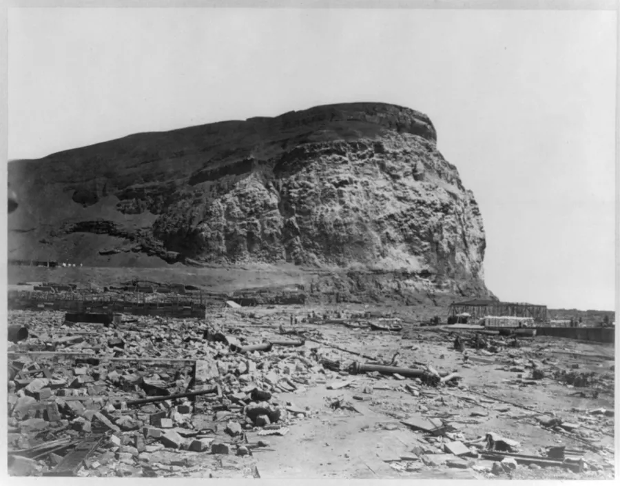 Arica in ruins after the earthquake of 1868, beneath the headland of the Morro