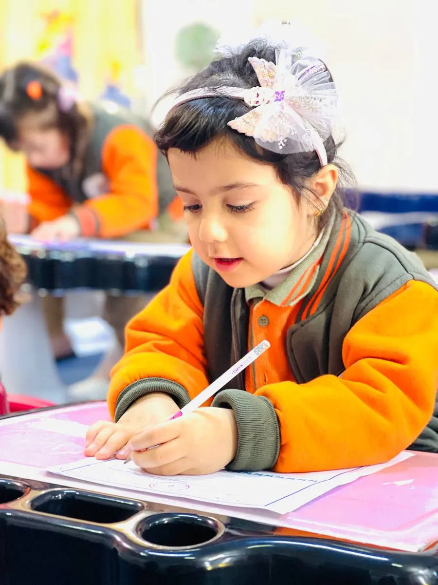 A schoolgirl writing with her left hand