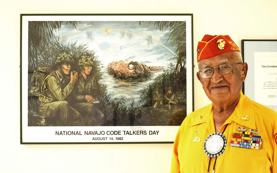 Navajo code talker veteran Thomas Begay with a framed picture marking National Navajo Code Talkers Day