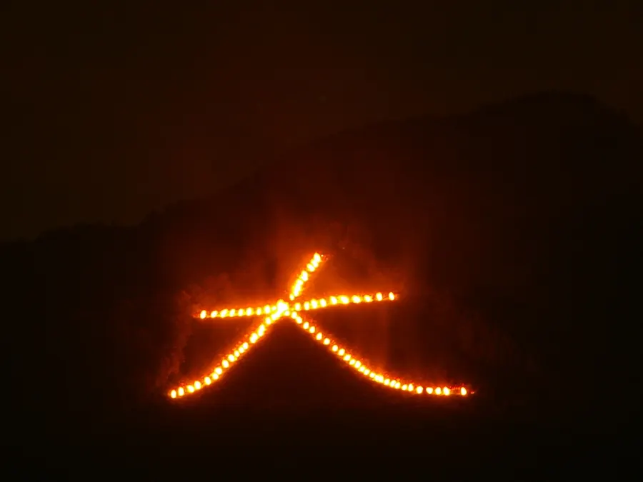 The character 'dai', meaning 'great', burns on the mountainside above Kyoto during the Gozan Okuribi