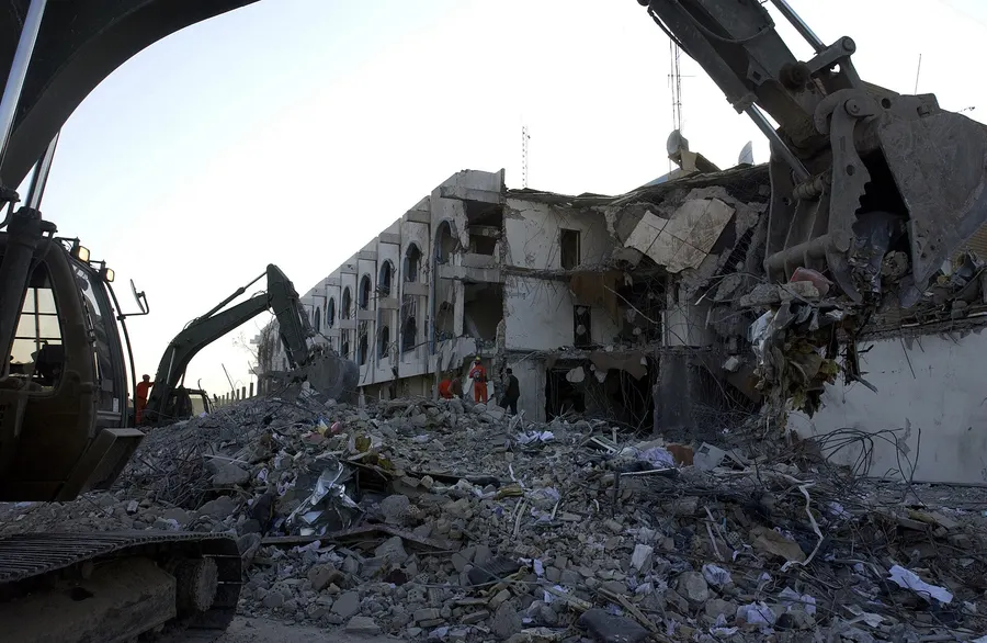 Excavators clear the rubble of the UN headquarters at the Canal Hotel in Baghdad after the bombing of 19 August 2003