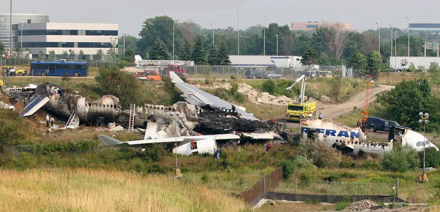 The burnt-out wreck of Air France Flight 358 in the ravine beyond the runway at Toronto Pearson airport