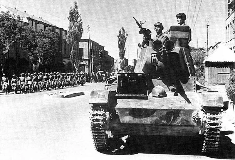 Soviet tank crews of the 6th Armoured Division drive a T-26 tank through the streets of Tabriz in 1941