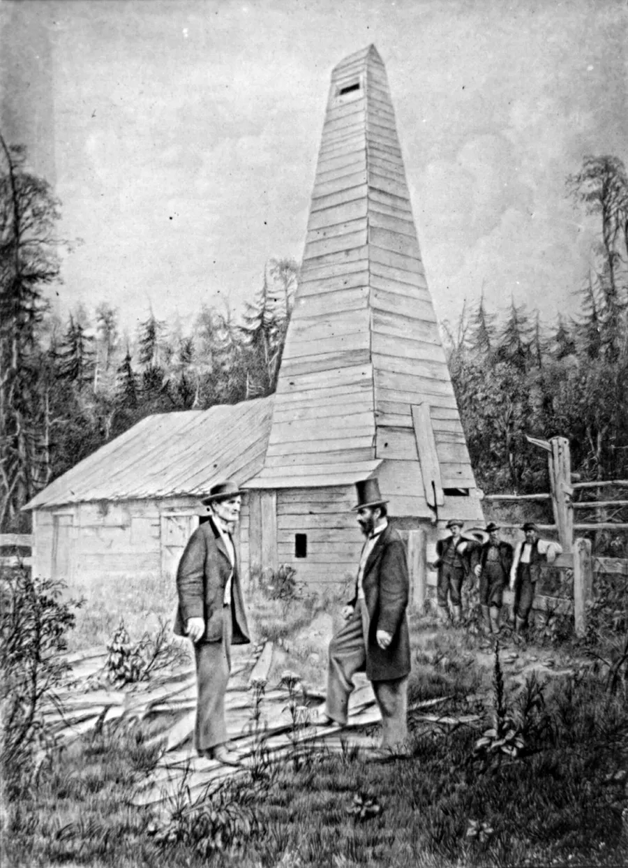 Edwin L. Drake (right) beside his well at Titusville, in a retouched photograph reproduced in 1890
