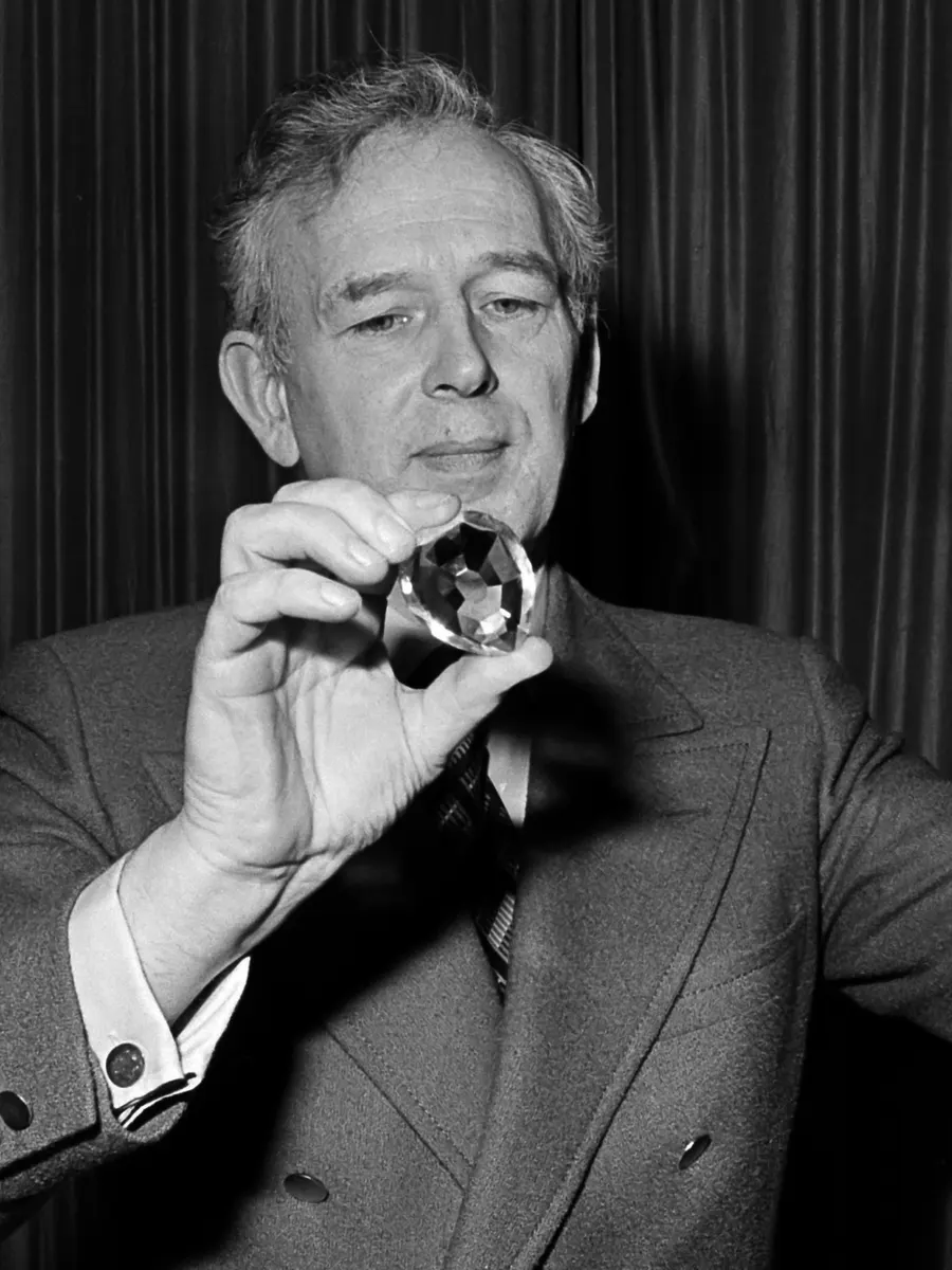 Norris McWhirter, co-founder of The Guinness Book of Records, holding up a model of a record-breaking diamond at the launch of a Dutch edition in 1977