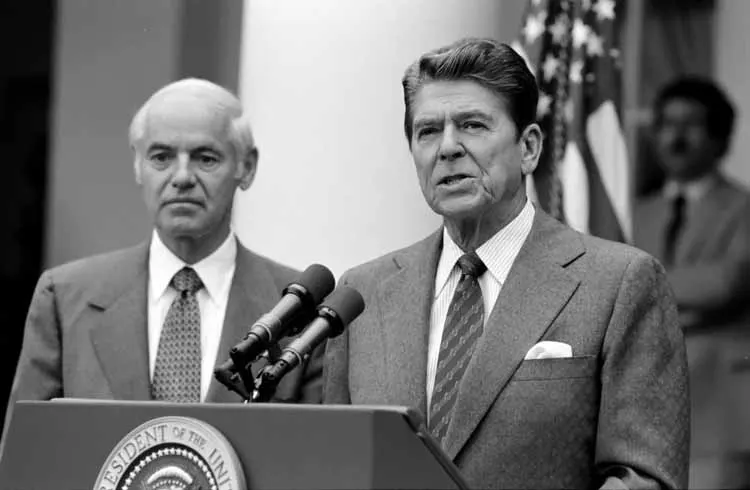 President Ronald Reagan, with Attorney General William French Smith, speaks about the air traffic controllers' strike in the White House Rose Garden on 3 August 1981