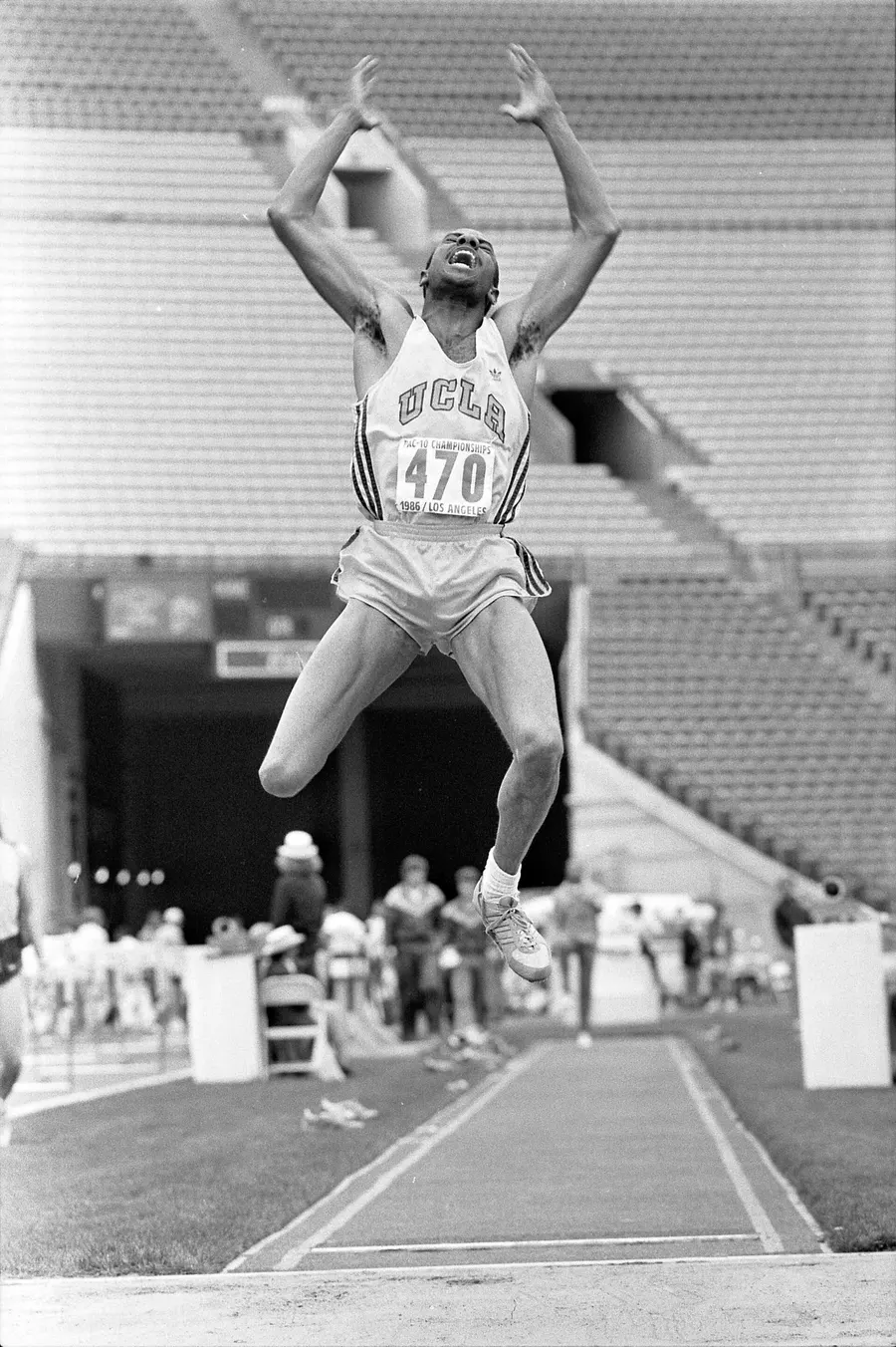 Mike Powell in mid-leap for UCLA at a college meet in 1986, five years before his world record