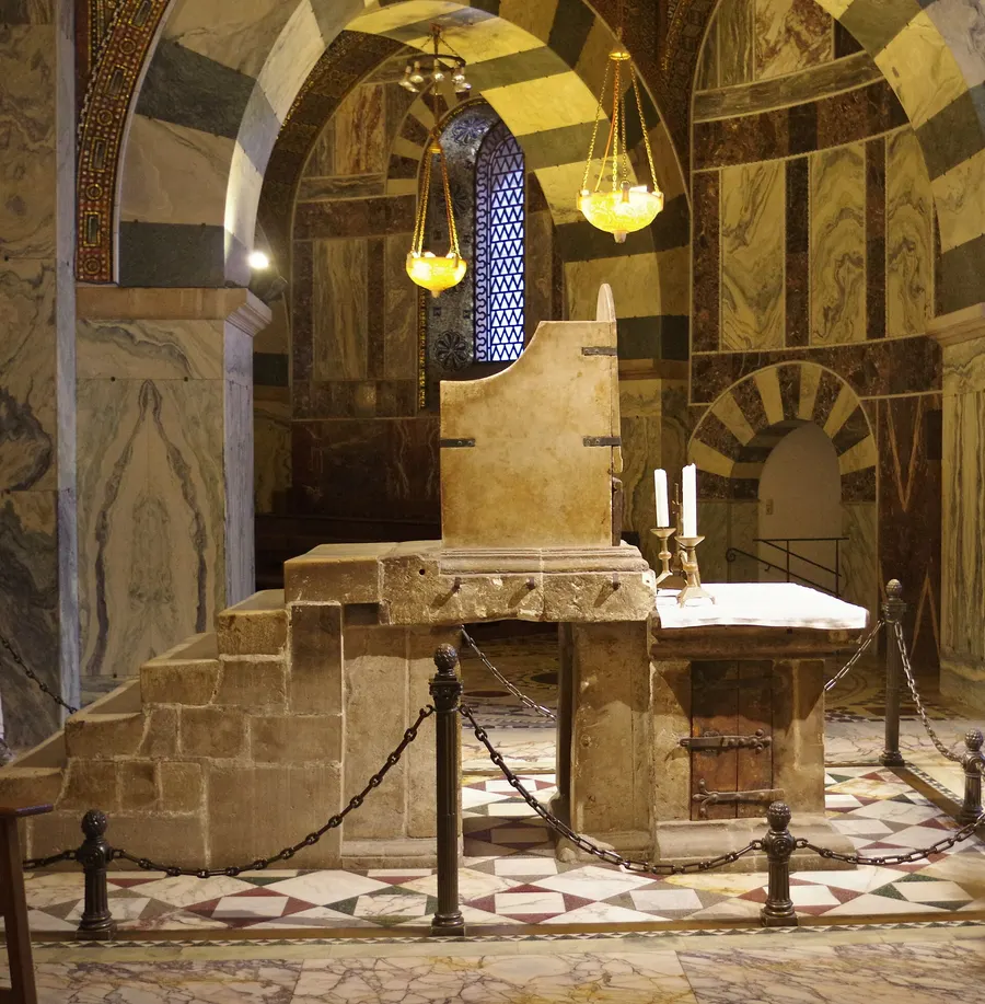 The stone throne of Charlemagne in the gallery of Aachen Cathedral, on which Otto I was enthroned