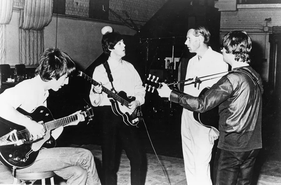 The Beatles with their producer George Martin in the studio, 1966.