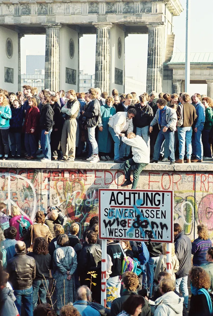 Crowds on the Berlin Wall at the Brandenburg Gate on 9 November 1989, the night the Wall opened.
