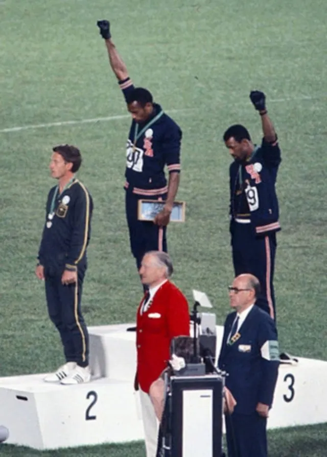 Tommie Smith and John Carlos on the podium with Peter Norman, Mexico City, October 1968.