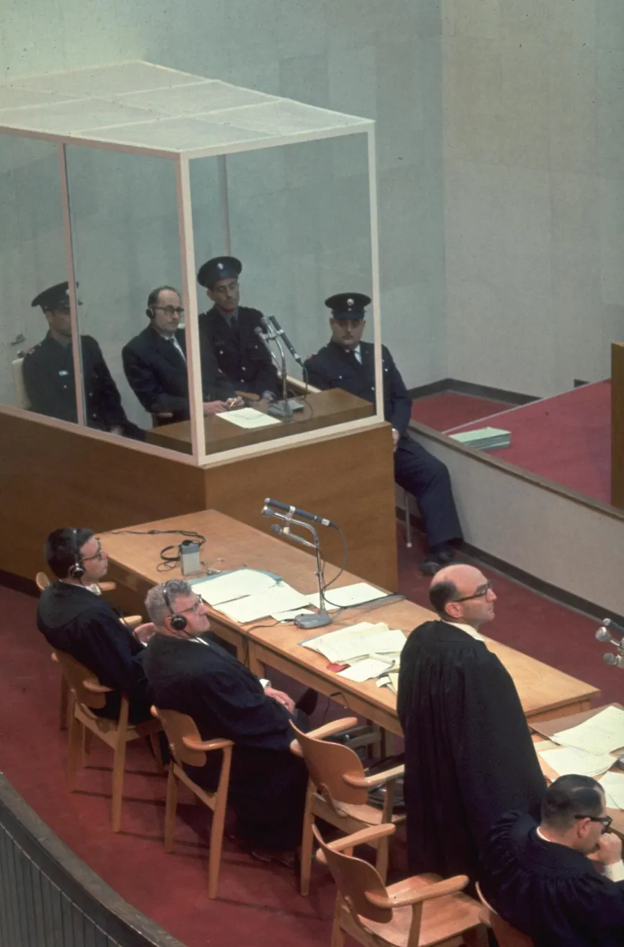 Adolf Eichmann, in a glass booth, at his trial in Jerusalem, 1961.