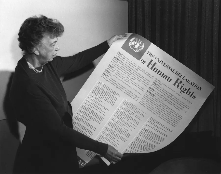 Eleanor Roosevelt holding a printed copy of the Universal Declaration of Human Rights.