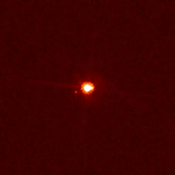 The dwarf planet Eris (centre) and its moon Dysnomia (left), photographed by the Hubble Space Telescope in 2006.