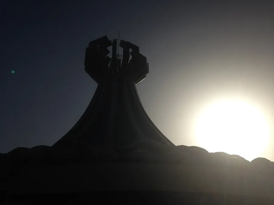 The monument to the victims of the Halabja chemical attack, seen against the light in 2018.