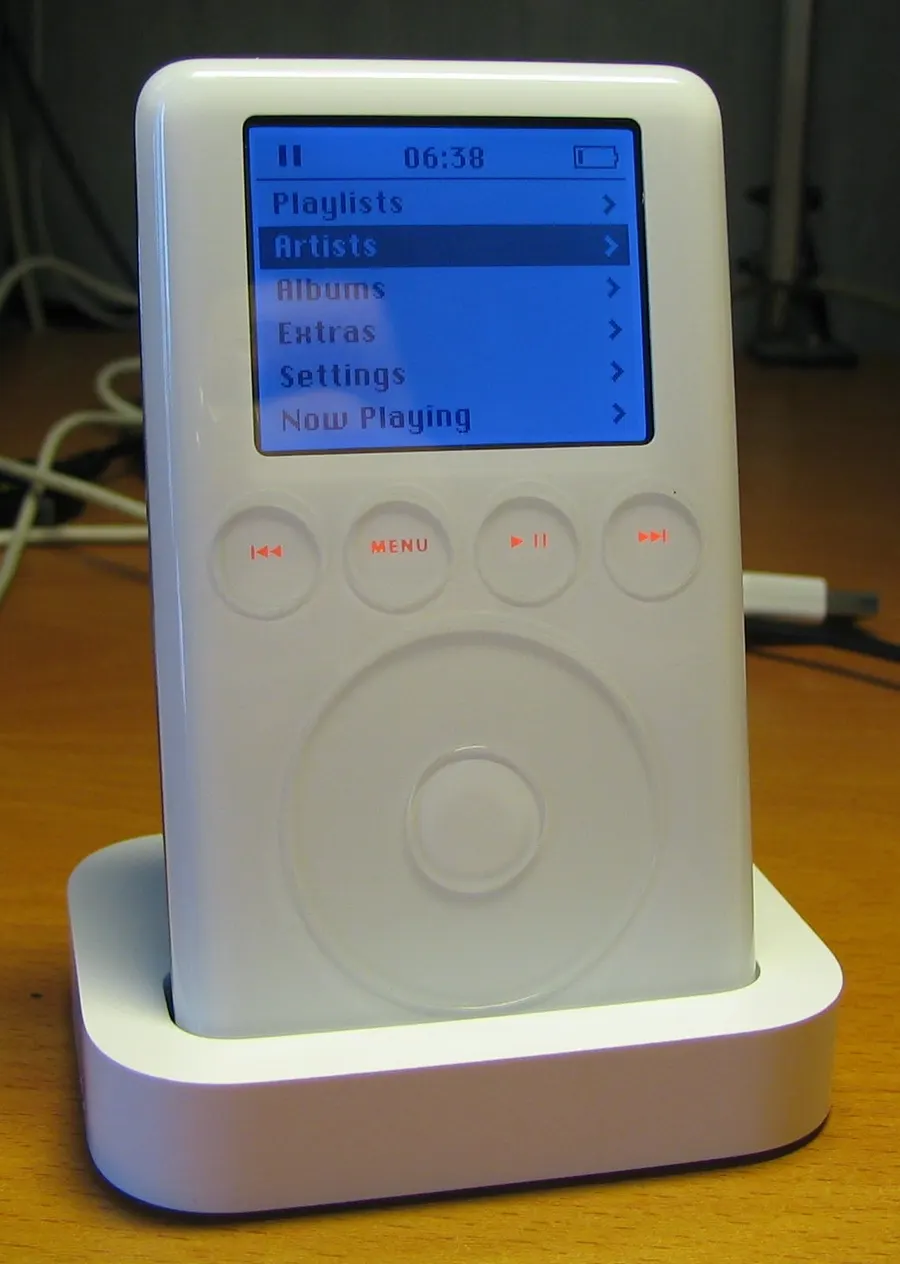 A third-generation iPod of 2003 in its dock; no freely licensed photograph of the original 2001 model exists.