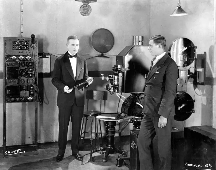 A 1926 photograph of Western Electric engineer E. B. Craft, on the left, demonstrating the Vitaphone sound system.