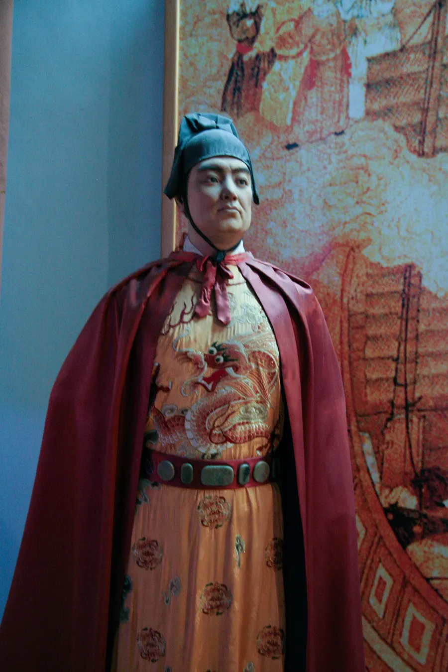 A modern figure of Admiral Zheng He in court dress, on display in a museum