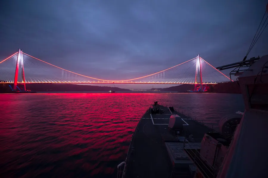 The Yavuz Sultan Selim Bridge lit up at dusk over the northern end of the Bosphorus, seen from the deck of an American destroyer
