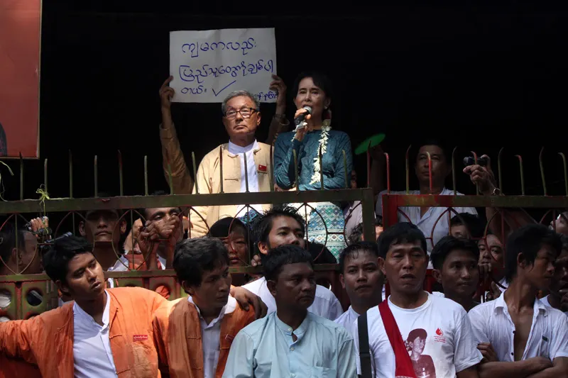 Aung San Suu Kyi greets supporters at her party's headquarters in Yangon after her release from house arrest in November 2010