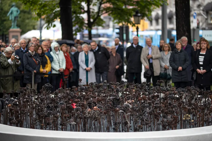 People gather at the unveiling of the Iron Roses, a memorial in Oslo to the victims of 22 July 2011