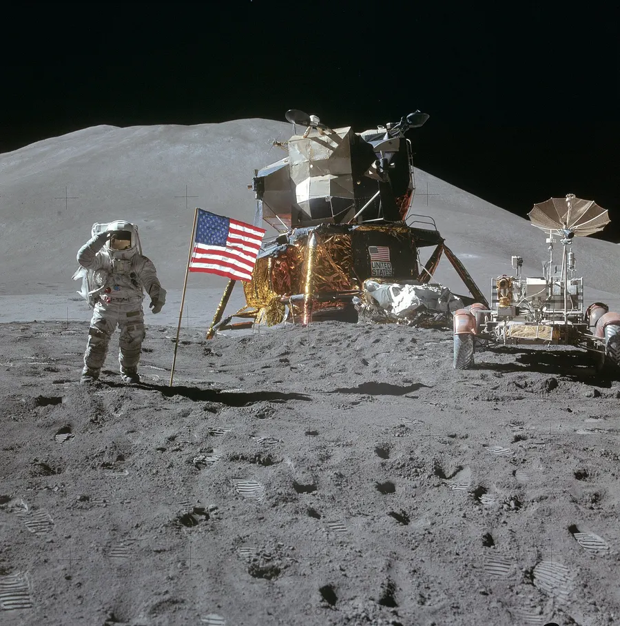 James Irwin salutes the flag beside the lunar module Falcon and the Lunar Roving Vehicle at Hadley, photographed by David Scott