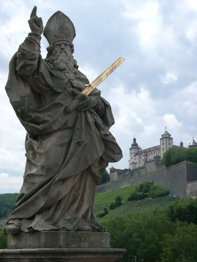 Statue of St Kilian on the Old Main Bridge in Würzburg, with the Marienberg Fortress behind