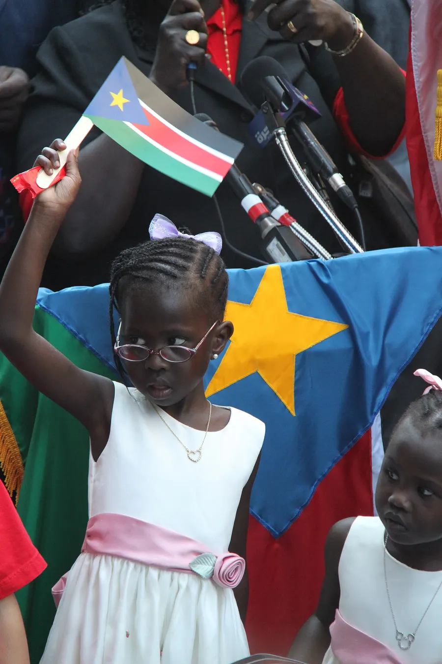 A young girl waves the new South Sudanese flag at the independence festivities in July 2011