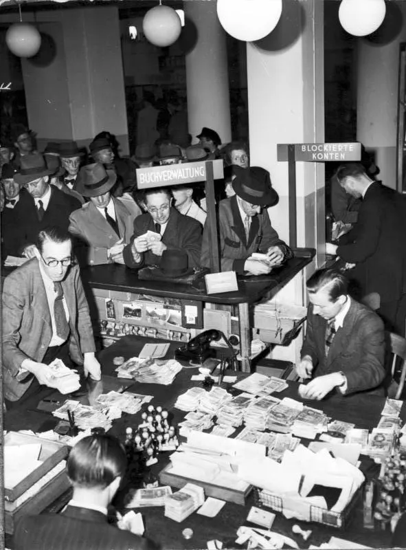 Bank clerks counting notes at an exchange counter during the currency reform of 1948 in western Germany