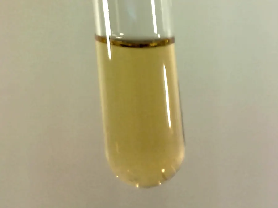 Liquid fluorine, a pale yellow liquid, in a glass tube cooled to about -196°C