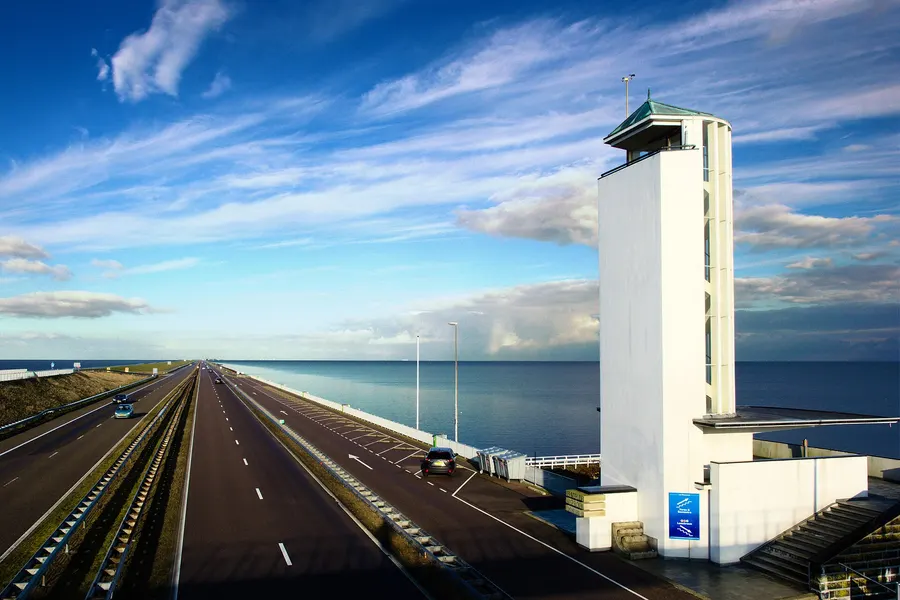 The Afsluitdijk dam with its monument tower, between the Wadden Sea and the IJsselmeer