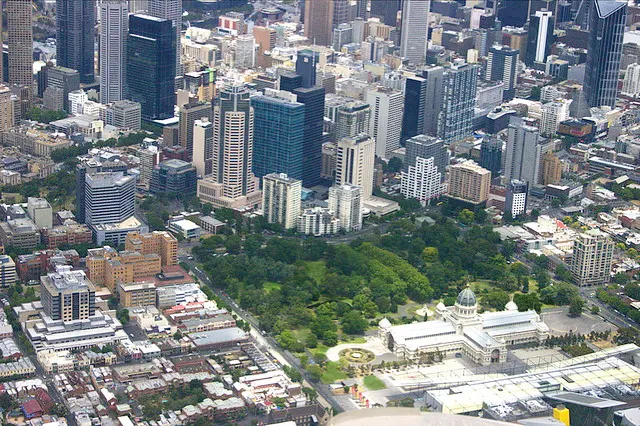 Melbourne from the air, with the Royal Exhibition Building among the trees in the foreground.