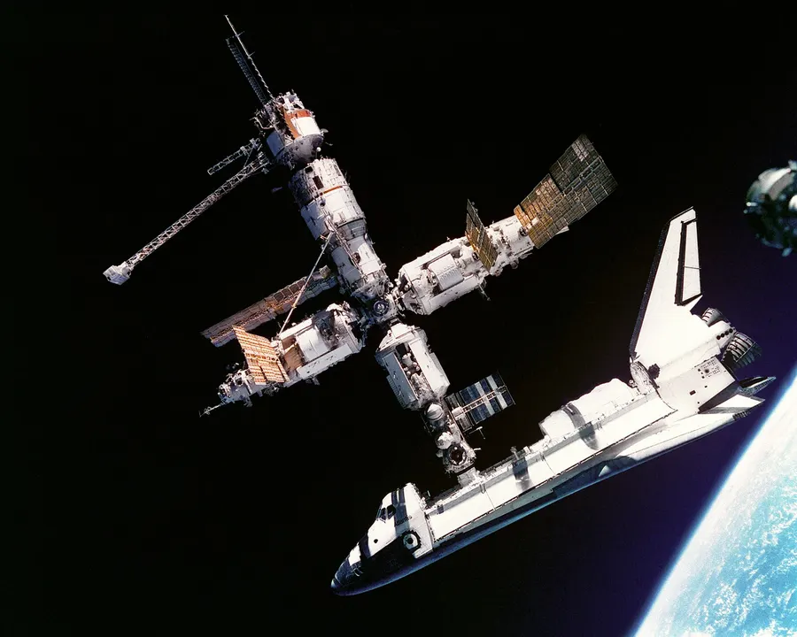 The space shuttle Atlantis docked to Mir, photographed by the Mir-19 crew in July 1995.