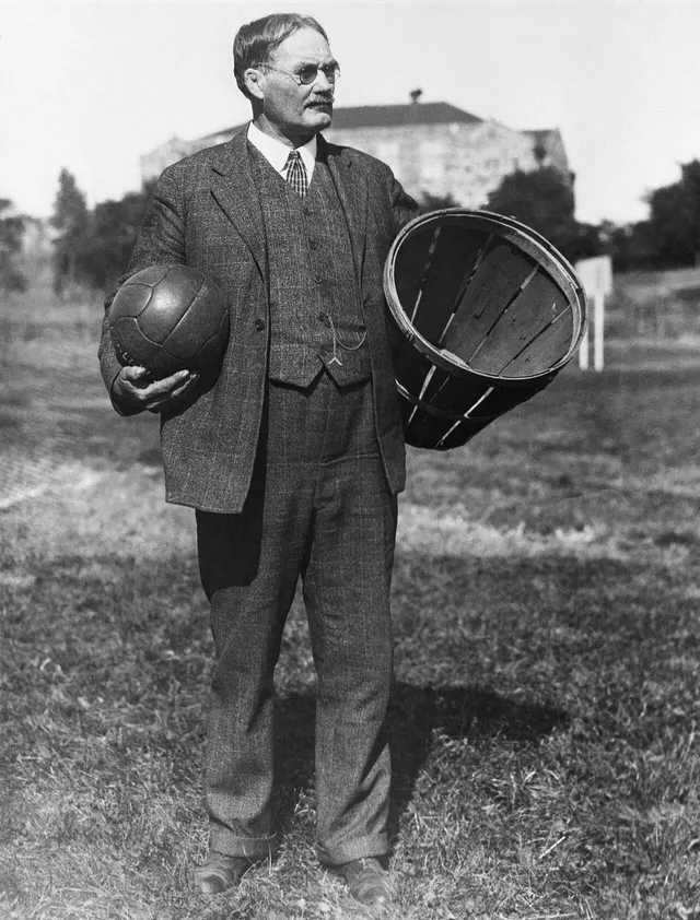 James Naismith with a ball and a peach basket.