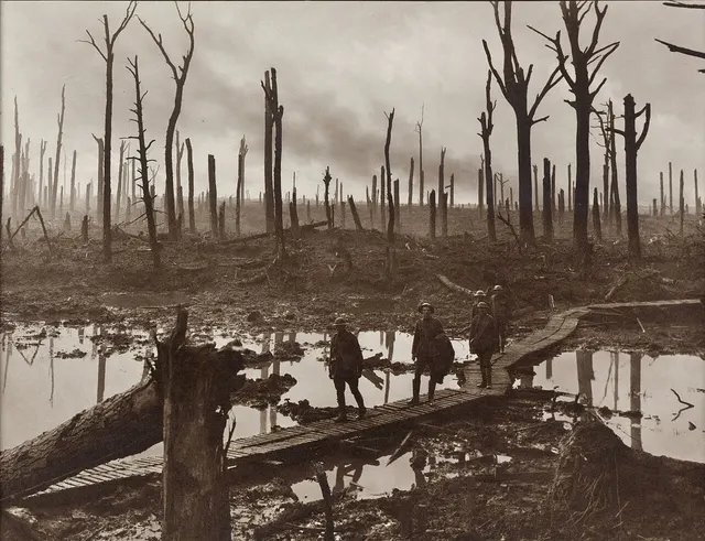 Australian gunners on a duckboard track through Chateau Wood near Ypres, 29 October 1917, photographed by Frank Hurley.