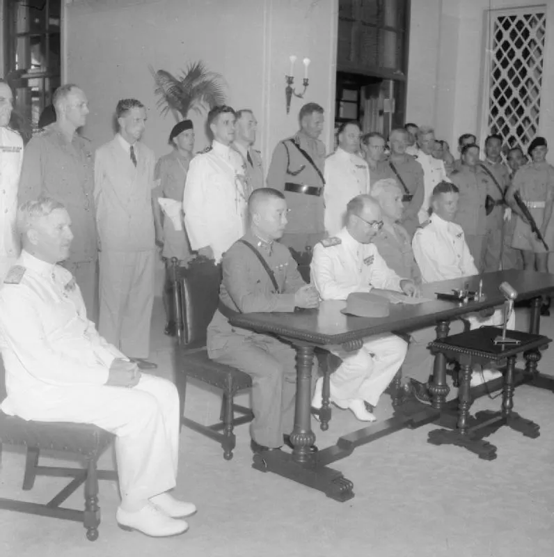 Rear Admiral Harcourt, seated second from right, at the ceremony marking the Japanese surrender of Hong Kong in 1945