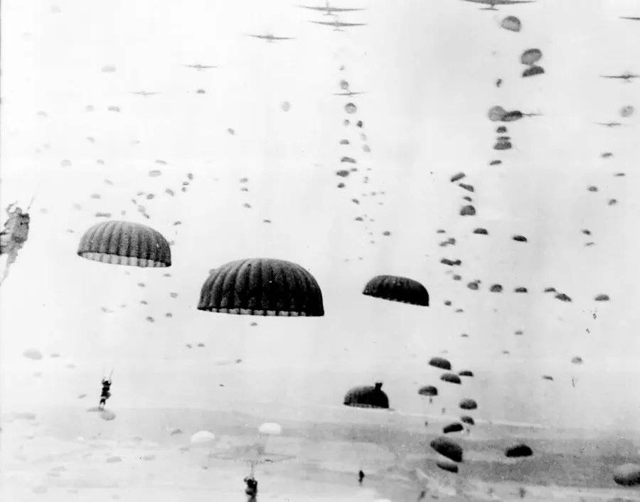 Parachutes open overhead as waves of Allied paratroops land in the Netherlands in September 1944