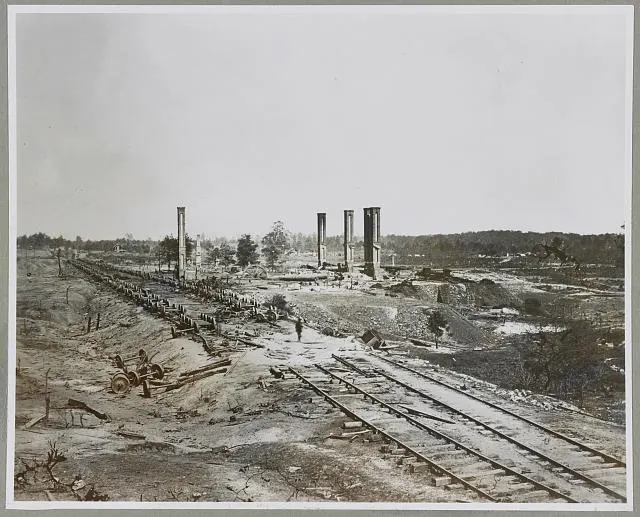 Ruins of the rolling mill and railway cars destroyed by Confederate troops as they left Atlanta in 1864, photographed by George N. Barnard