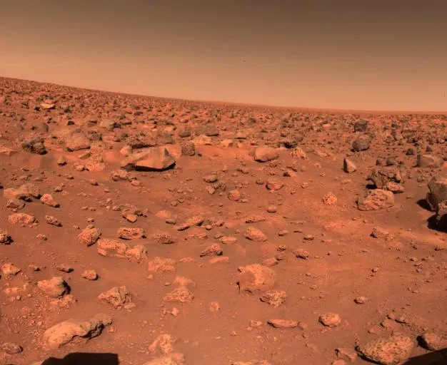 The first colour picture taken by the Viking 2 lander at Utopia Planitia, showing rocks strewn across the plain and part of the spacecraft
