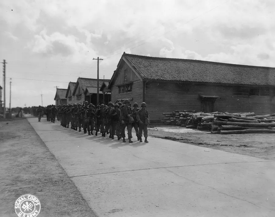 American troops of the 7th Infantry Division march from the docks at Inchon after landing in September 1945