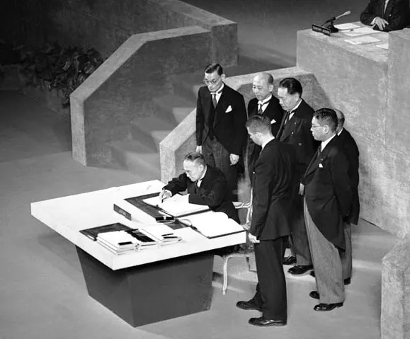 Prime Minister Shigeru Yoshida and members of the Japanese delegation sign the Treaty of San Francisco on 8 September 1951