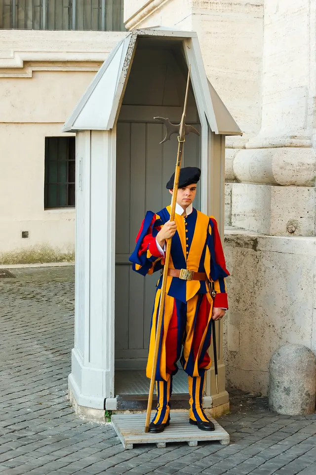A Swiss Guard on duty in the Vatican in the corps' striped uniform, 2013.