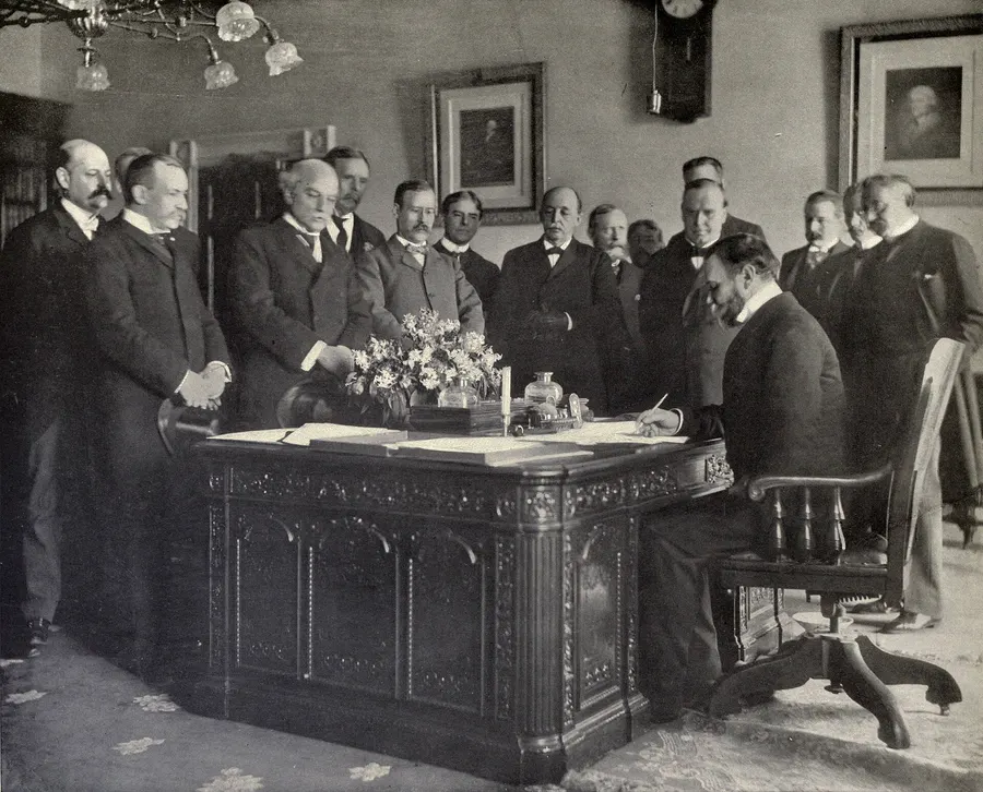 Secretary of State John Hay signing the Treaty of Paris memorandum of ratification in 1899, a few months after the treaty itself was signed.