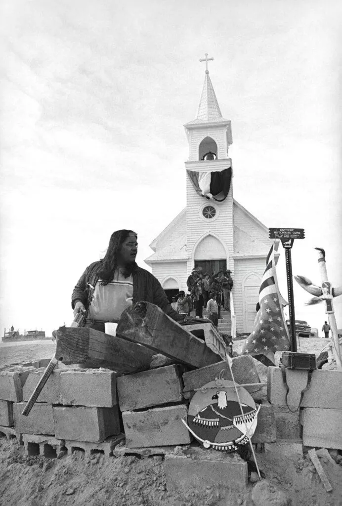 An AIM member in a bunker outside the Wounded Knee church, 2 March 1973.