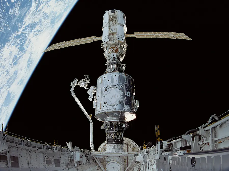 Astronauts at work on Zarya and the American Unity module in December 1998, days after they were joined.